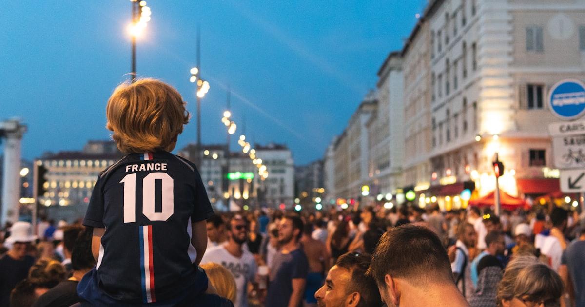 Crowd of football fans celebrating in a city street