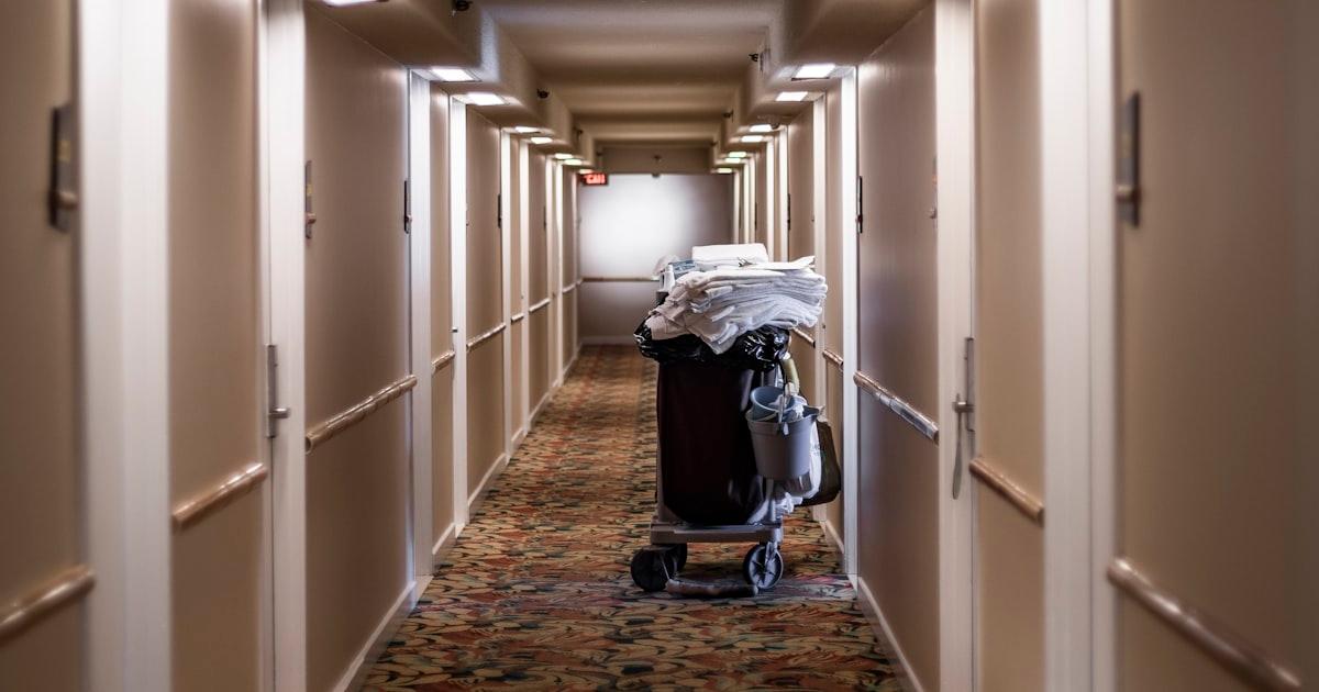A housekeeping cart in a hallway during a short-term rental turnover