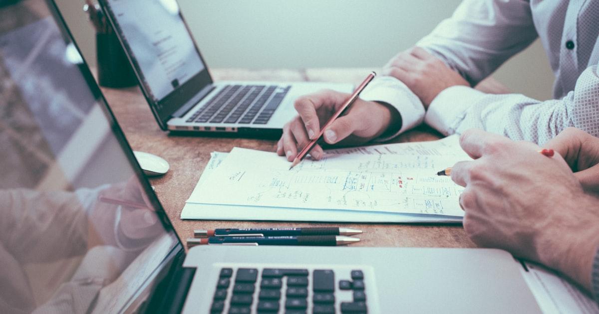 A short-term rental host reviewing rental finances and tax paperwork at a desk